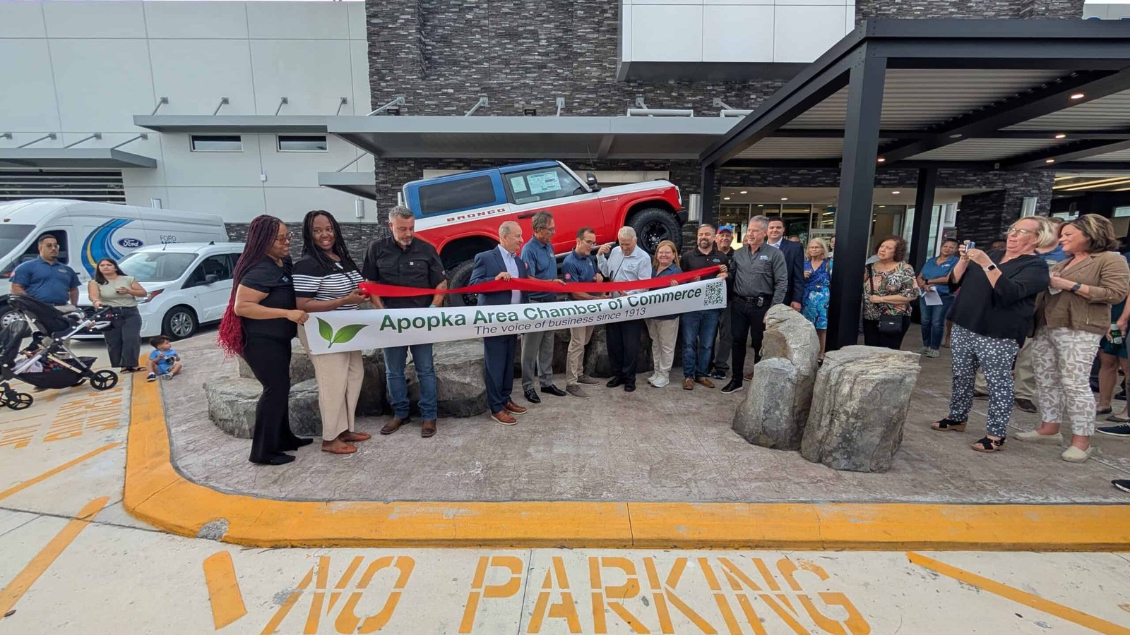 Brightly lit ribbon-cutting ceremony outside the Apopka Area Chamber of Commerce, celebrating local business growth and community engagement in Apopka, Florida.