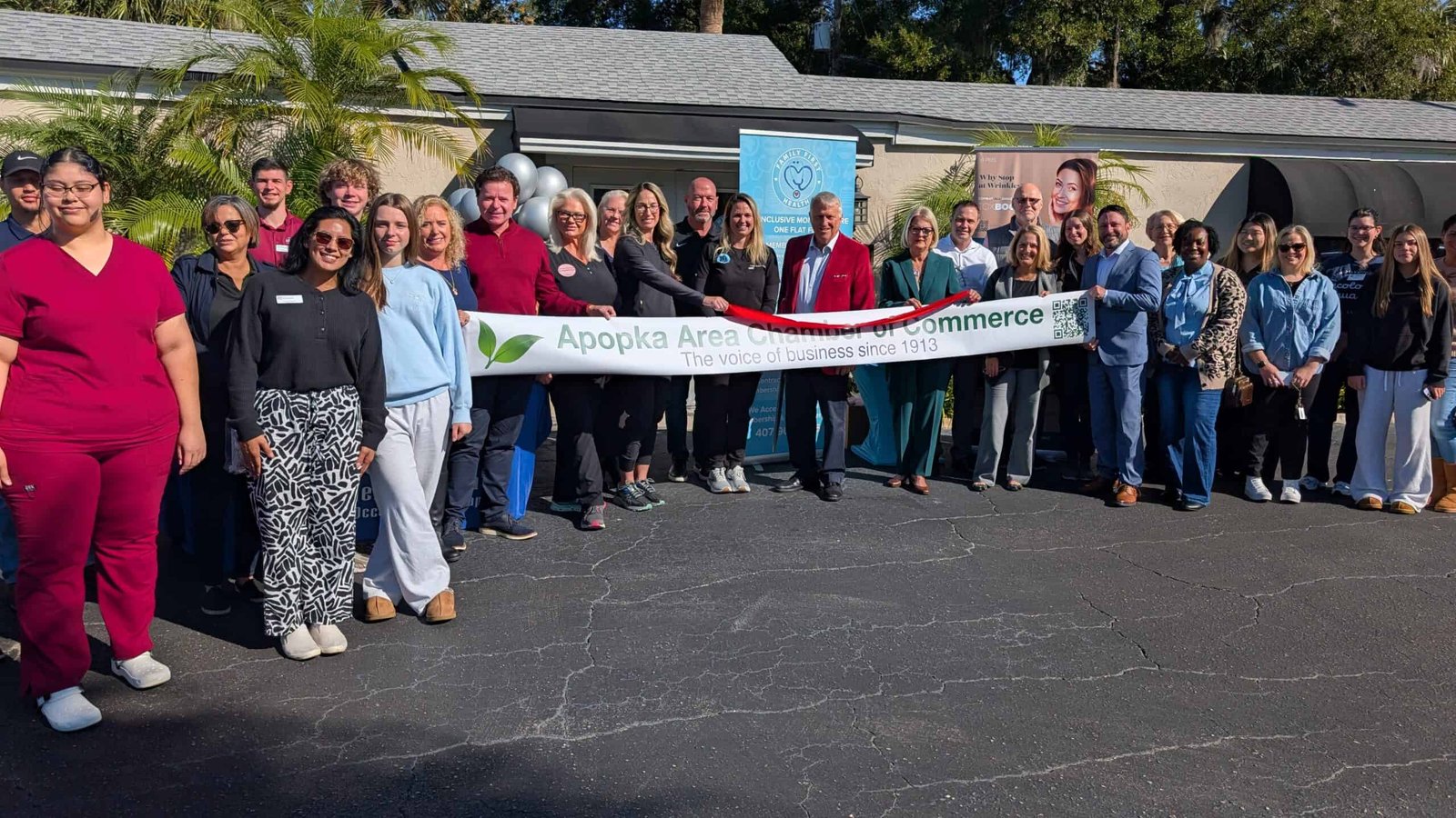 Dedicated group of business professionals and community leaders at the Apopka Area Chamber of Commerce ribbon-cutting event, promoting local economic growth and fostering networking opportunities in Apopka.